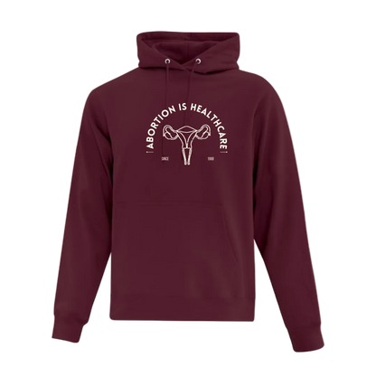 Maroon hoodie with graphic design reading Abortion is Healthcare