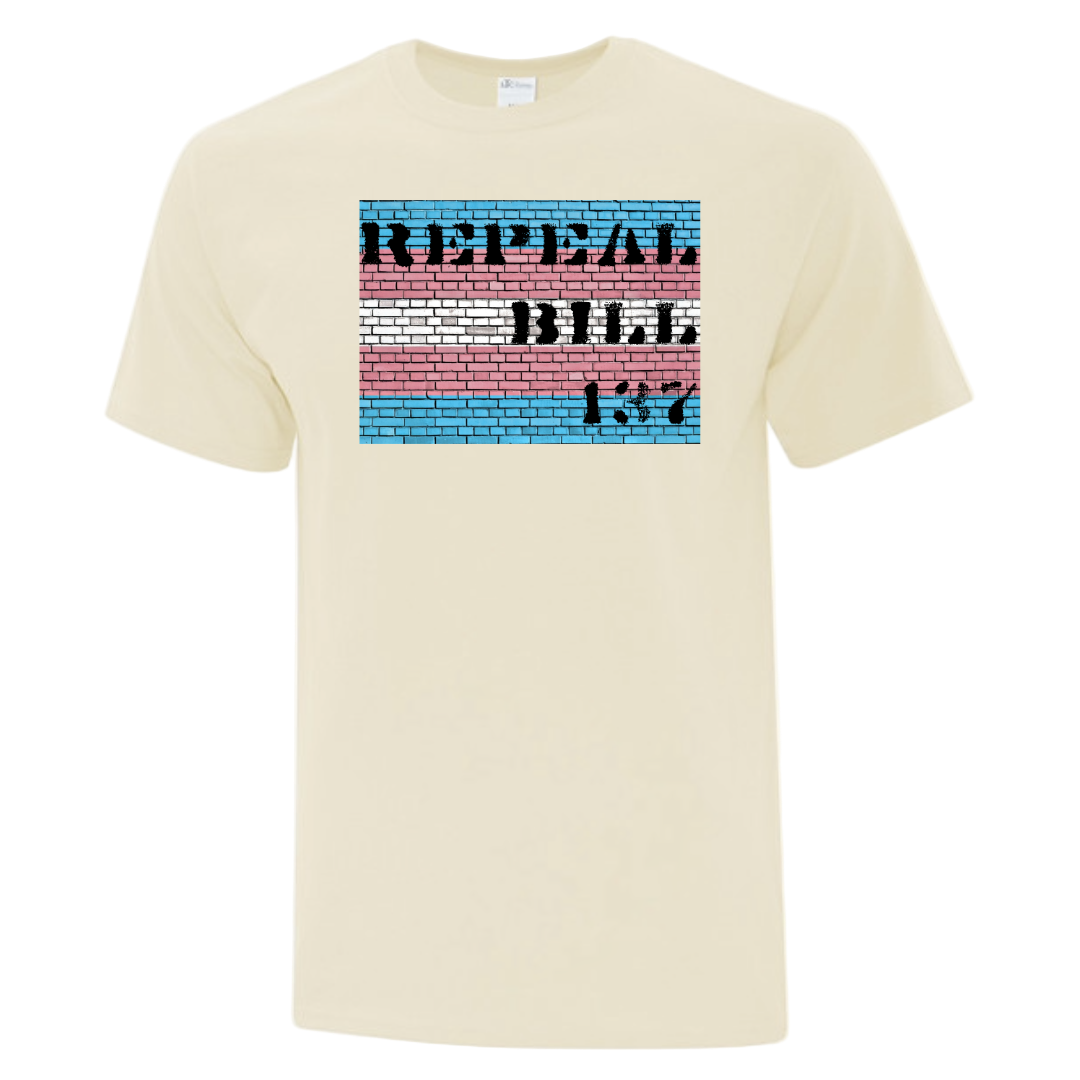 Beige t-shirt with a colorful graphic. "Repeal Bill 137" on a Brick Wall that is the color of the Trans Flag