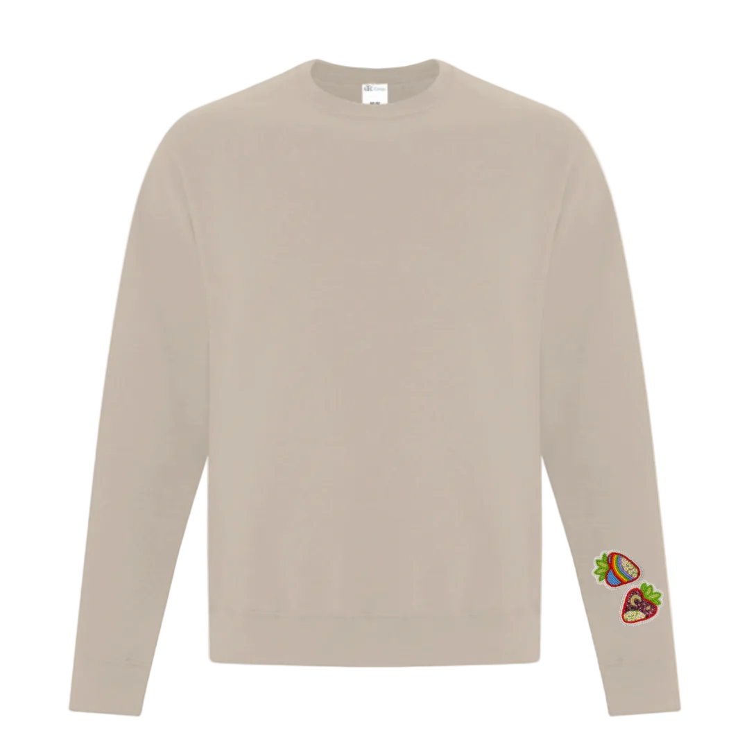 Sand Colored crewneck sweater with strawberry graphic on left sleeve near cuff 